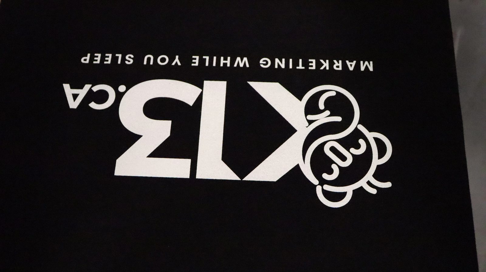 K13 logo on black tee — crisp print detail