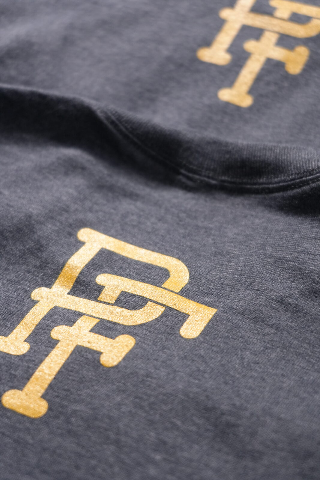 Gold monogram screen print on charcoal tee